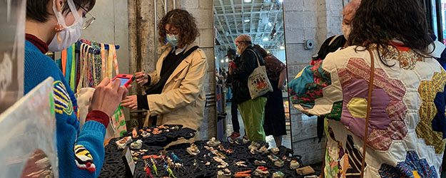 Shoppers and sellers masked up at Artists & Fleas Williamsburg enjoying a day of discovery