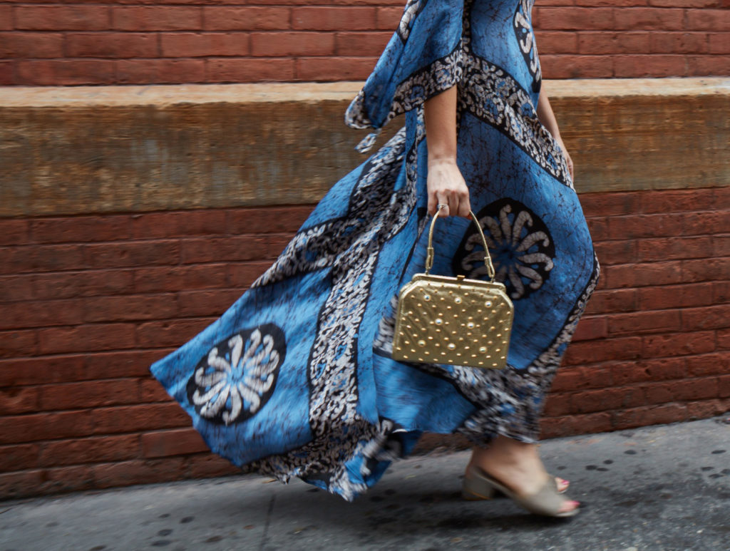 Woman in vintage dress holding purse