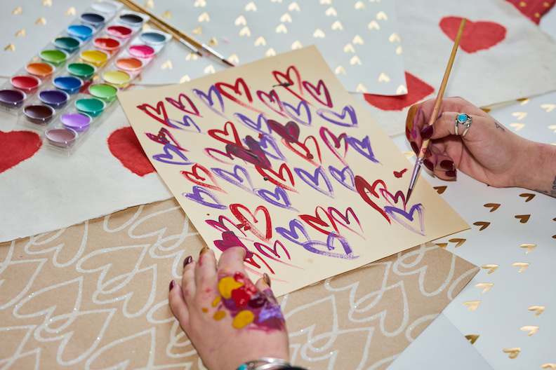 hands painting a valentine