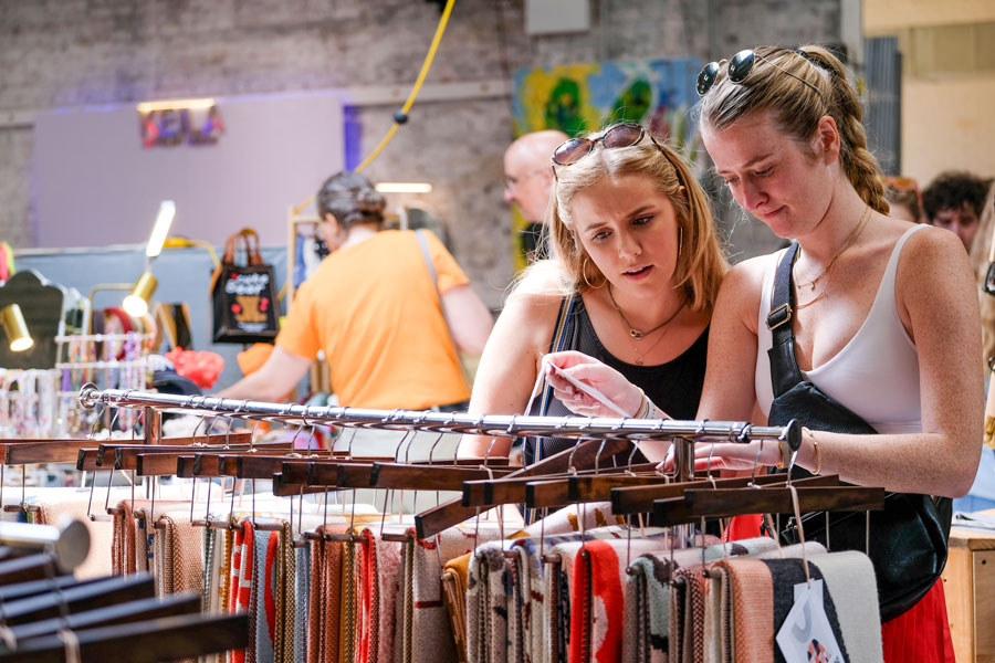 Shoppers browse Biquette one-of-a-kind vibrant throw blankets