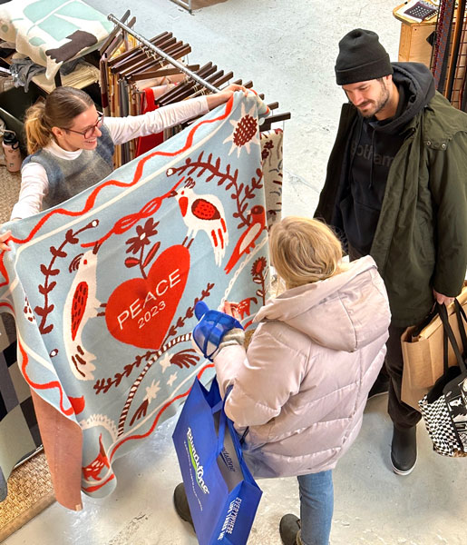Shoppers browse Biquette one-of-a-kind vibrant throw blankets